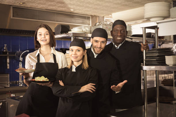 istock Woman waiter with kitcheners are standing together on kitchen 951186706