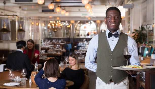 istock African American waiter with serving tray 951186800