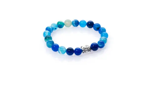 Photo of Handmade bracelet isolated on white background. Blue beads