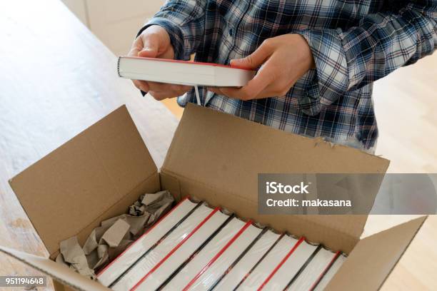 Author Opens Package With Samples Of Her New Book And Checks The Hardcover Stock Photo - Download Image Now