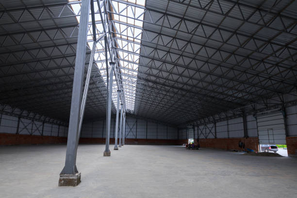 istock A huge metal construction warehouse. Grain dryer and threshing floor. Blurred-unrecognizable faces of people. Concept theme is the production of food and agricultural production. 951199632