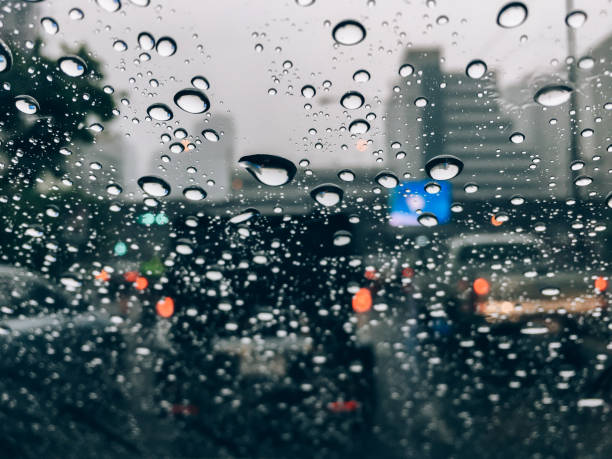 istock Rain drops on car front window in rainy day 951203984