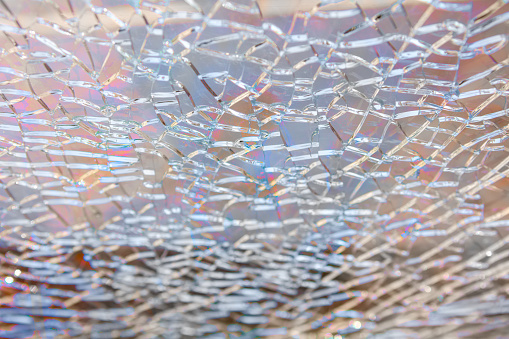 Abstract background: broken tempered glass texture. Selective focus, High angle view.