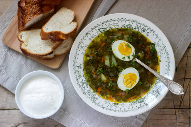 istock Vegetarian sorrel soup with egg, served with sour cream and bread. Rustic style. 951209190