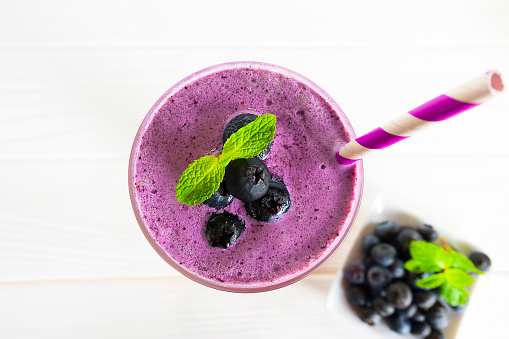 blueberry smoothies juice beverage healthy the taste yummy In glass drink episode morning on wood white from the top view.