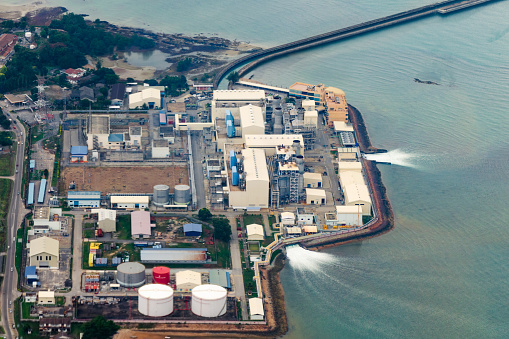 Aerial view of an industrial plant that uses seawater and returns it back. Use of natural resources, water pollution.  Malaysia, Petronas.