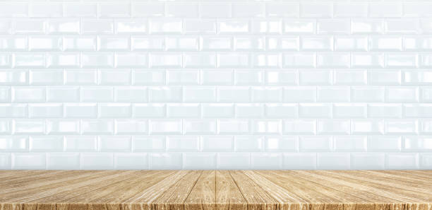 istock Wood plank table top at white glossy ceramic tile wall background,Mock up for display or montage of product,Banner or header for advertise on social media 951224326