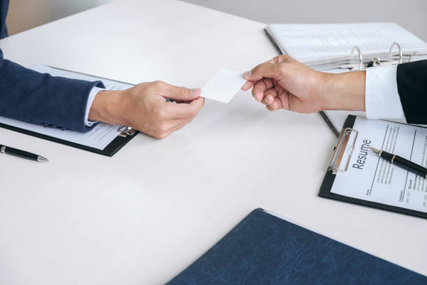 istock Interviewer or Board reading a resume during job interview, Employer interviewing a young male job seeker for recruitment talking in modern office and filing card, employment and recruitment concept 951228854
