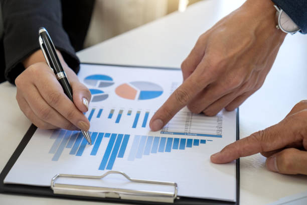 istock Teamwork process, Business team managers colleagues discussing and analysis new plan financial graph data and marketing documents report on office table 951230388