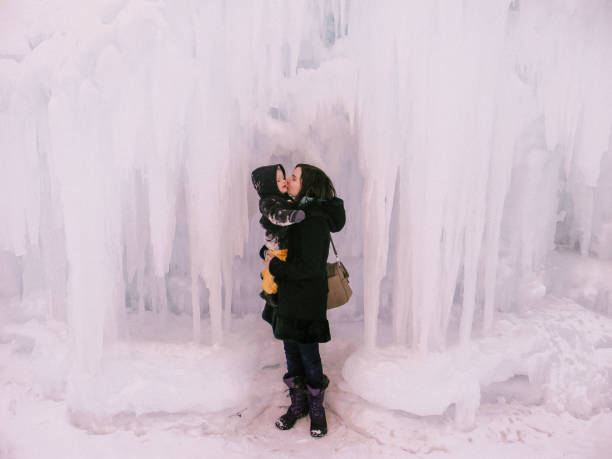 istock Mother Kissing Son By Icicles 951233758