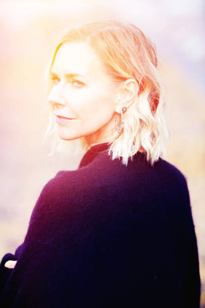 istock beautiful blond woman standing outside and looking sad 951236622