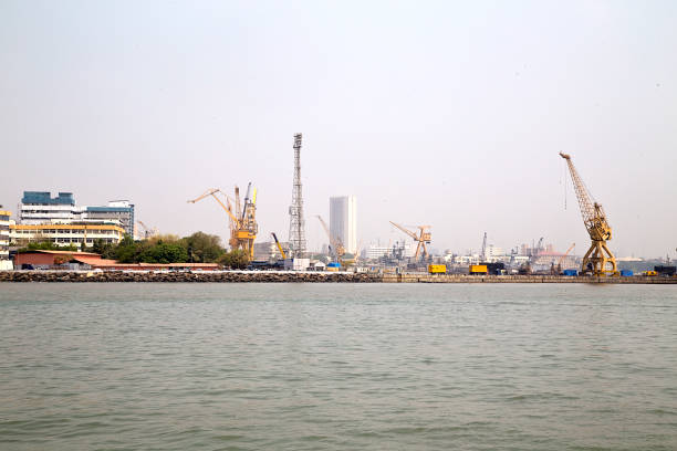 Cranes and cargo in a harbor in Mumbai, India