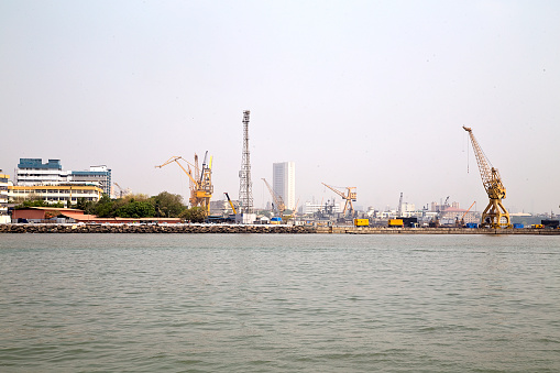 Seascape with construction cranes at port, Maharashtra