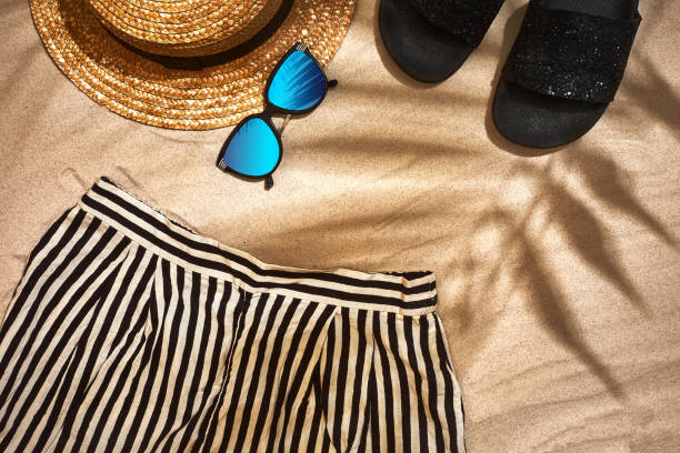 istock Top view of summer accessories on sandy beach 951245864