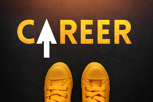 Career seeker looking for a job, conceptual image with young unemployed person in yellow sneakers standing