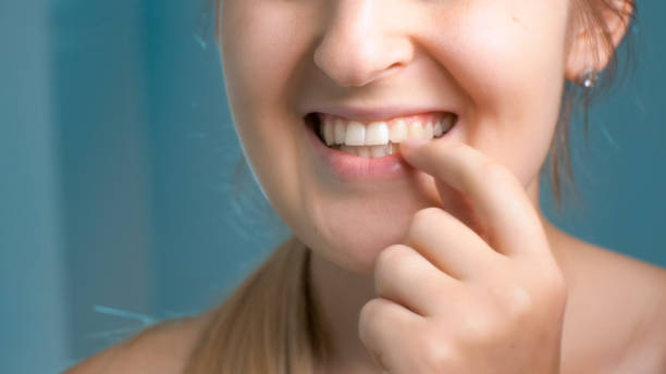 istock Closeup image of young woman checking her teeth at bathroom 951280478