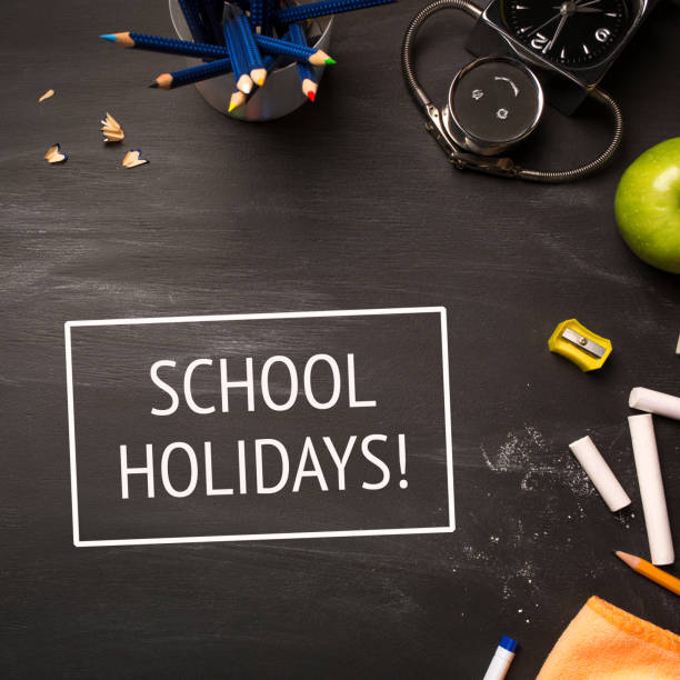 istock text school holidays and school supplies on chalk Board top view 951281242