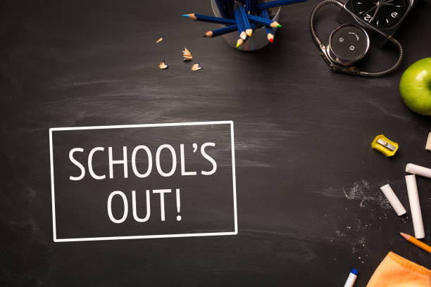 istock text school's out and school supplies on chalk Board top view 951283280