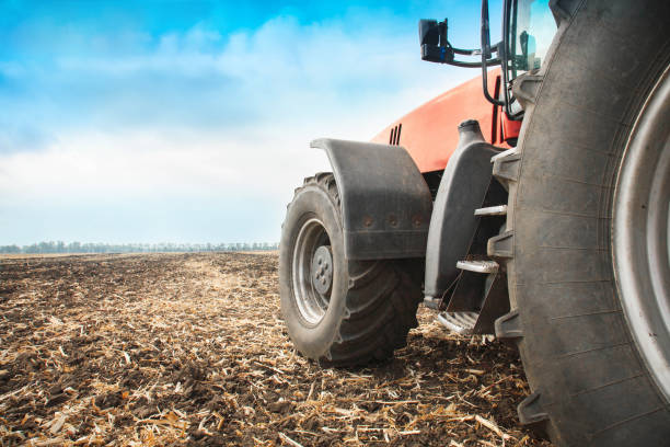 istock Modern red tractor in the field close-up. 951283612