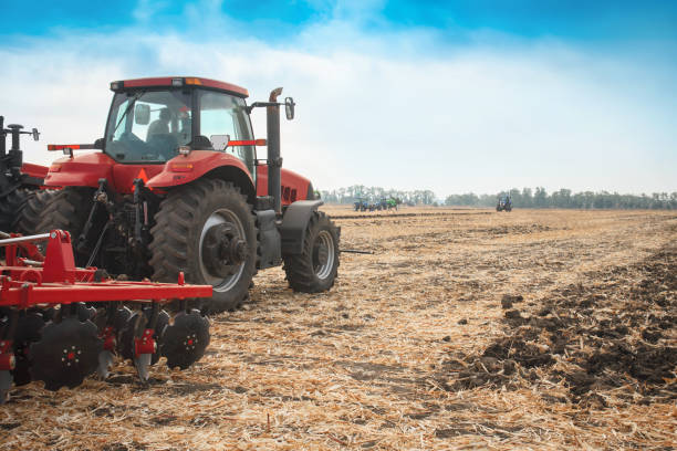 istock Red tractor in the field on a bright sunny day. 951283776