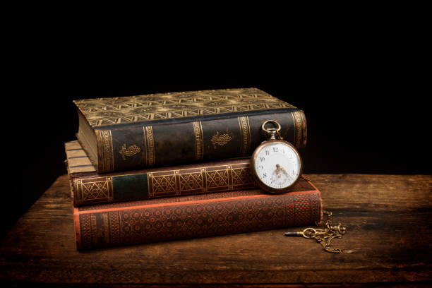 Old pocket watch and books with copy space