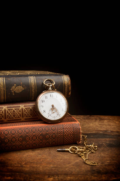istock Old pocket watch and books with copy space 951291528