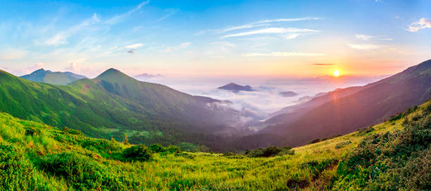 istock Beautiful sunrise in mountains with white fog below panorama 951291696