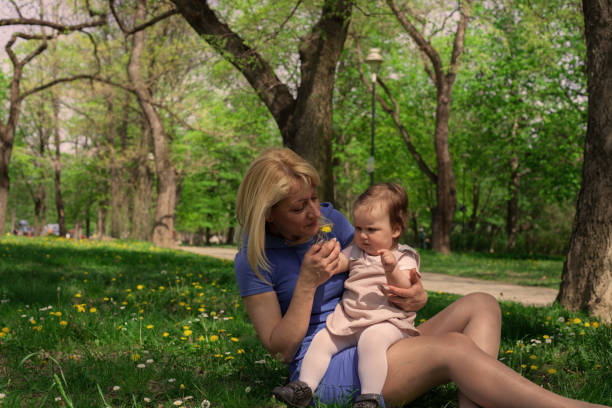 istock Baby touching flowers. 951294650