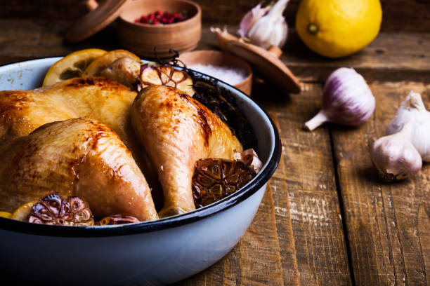 istock Roast chicken with garlic, thyme and lemon in cooking pan 951295688