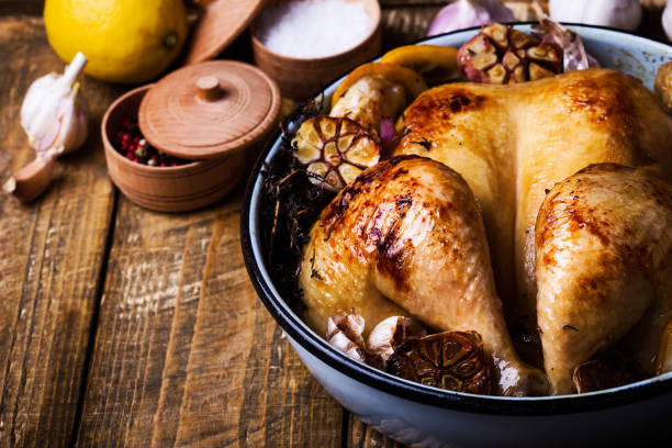 istock Roast chicken with garlic, thyme and lemon in cooking pan 951295708