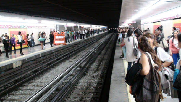 Scene Of Lots Of People Standing, Looking Around, Talking To One Another While Waiting For Metro At Metro Platform During Rush Hour In Mexico City Mexico