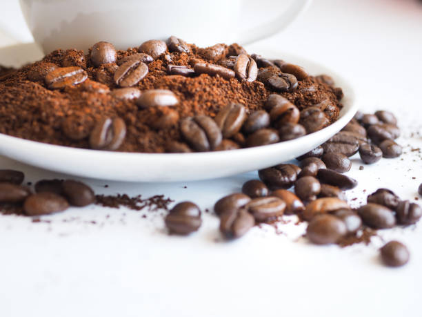istock coffee with a white cup and brown beans on a saucer 951306738