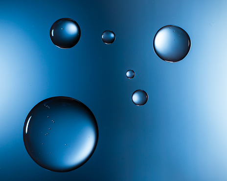 Water droplets on glass blue, macro