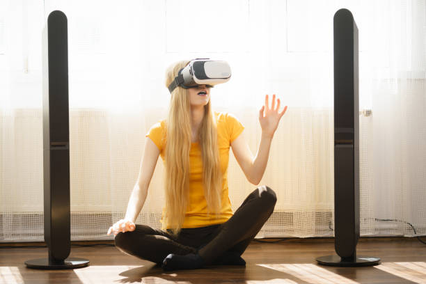 istock Girl wearing virtual reality goggles at home 951321560