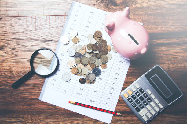istock coins and piggy bank with calculator on document 951322162