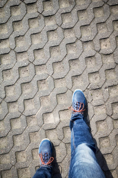 istock Looking down at blue shoes and jeans. 951340194