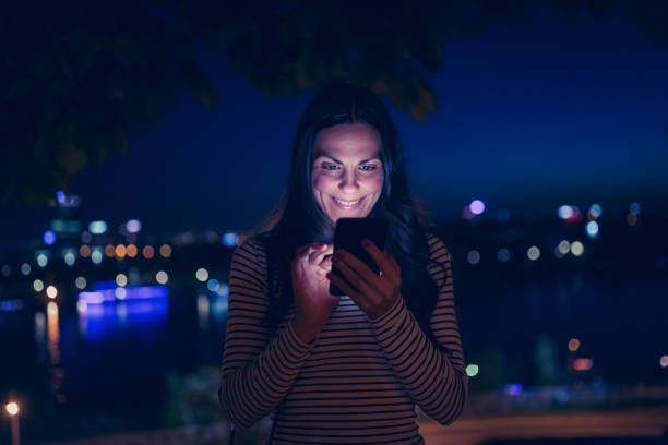 istock Young woman using smart phone outdoors. 951340866