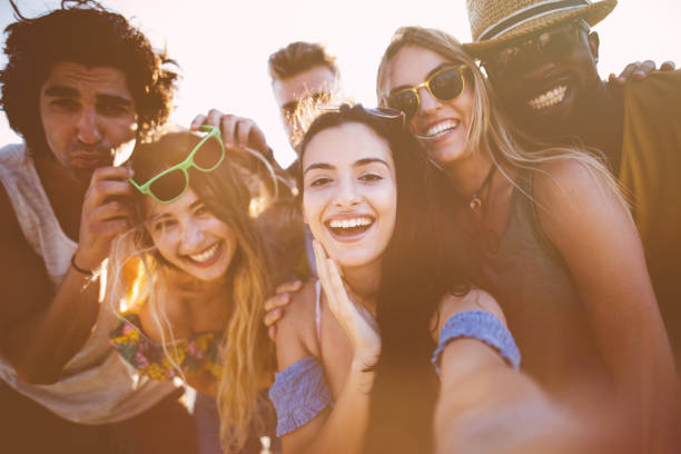 istock Young multi-ethnic hipster friends taking funny selfies on summer holidays 951345332
