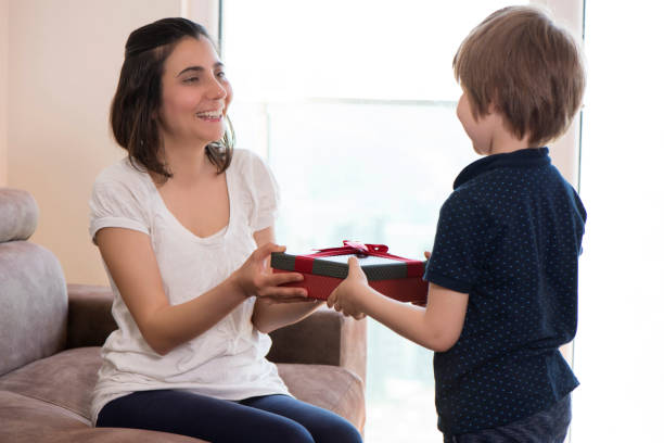 istock Boy Giving A Gift  To His Mother 951345908