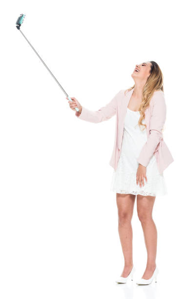 istock Beautiful woman holding a selfie stick 951349106