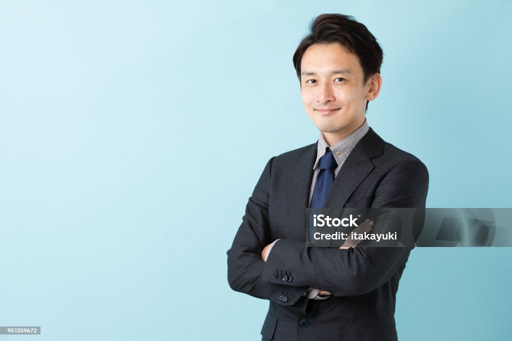portrait of asian businessman isolated on blue background Men Stock Photo