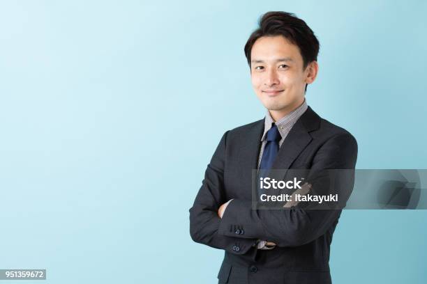 Portrait Of Asian Businessman Isolated On Blue Background Stock Photo - Download Image Now