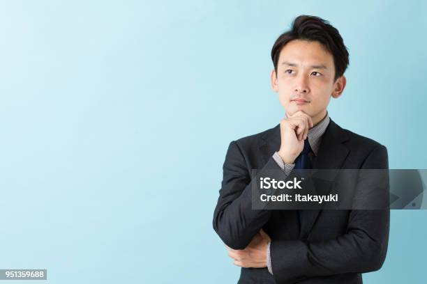 Portrait Of Asian Businessman Isolated On Blue Background Stock Photo - Download Image Now