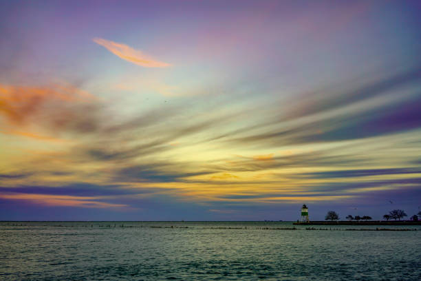 I rolled out of bed at 4 am and the sky was cloudy as far as the eye could see in every direction. But the weather app said that it would be sunny in Menominee in time for sunrise, so I drove right up there (50 miles). It was a good choice too! Check out this sunrise, and these dramatic, angry waters driven by high winds.