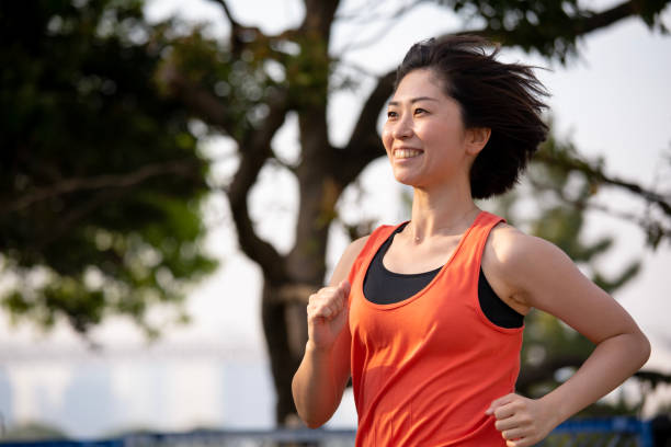 istock Woman running at sunset beach 951367098