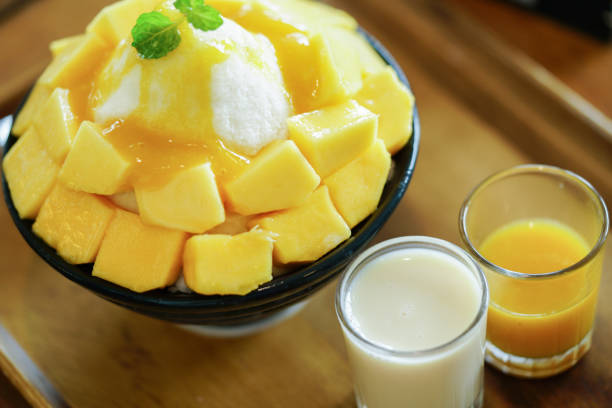 istock Korean shaved milk ice topped by fresh mango. Mango bingsu. 951374584