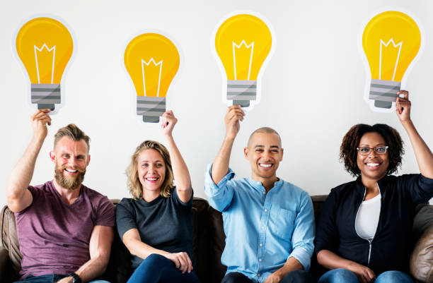 istock People carrying light bulb icons 951381750