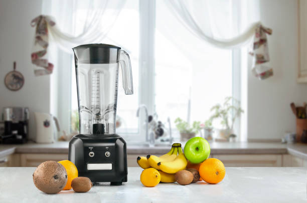 Blender and fruits on kitchen space Blender and fruits on kitchen space. Still life mini kiwi stock pictures, royalty-free photos & images