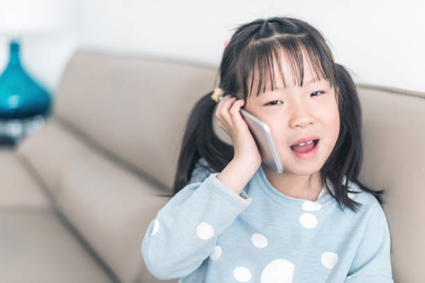 istock Girl using smartphone at home 951389770