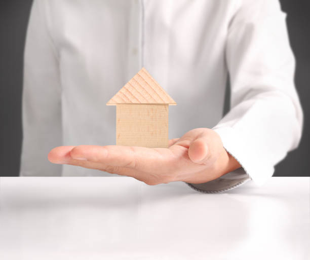 istock holding house representing home ownership 951392954